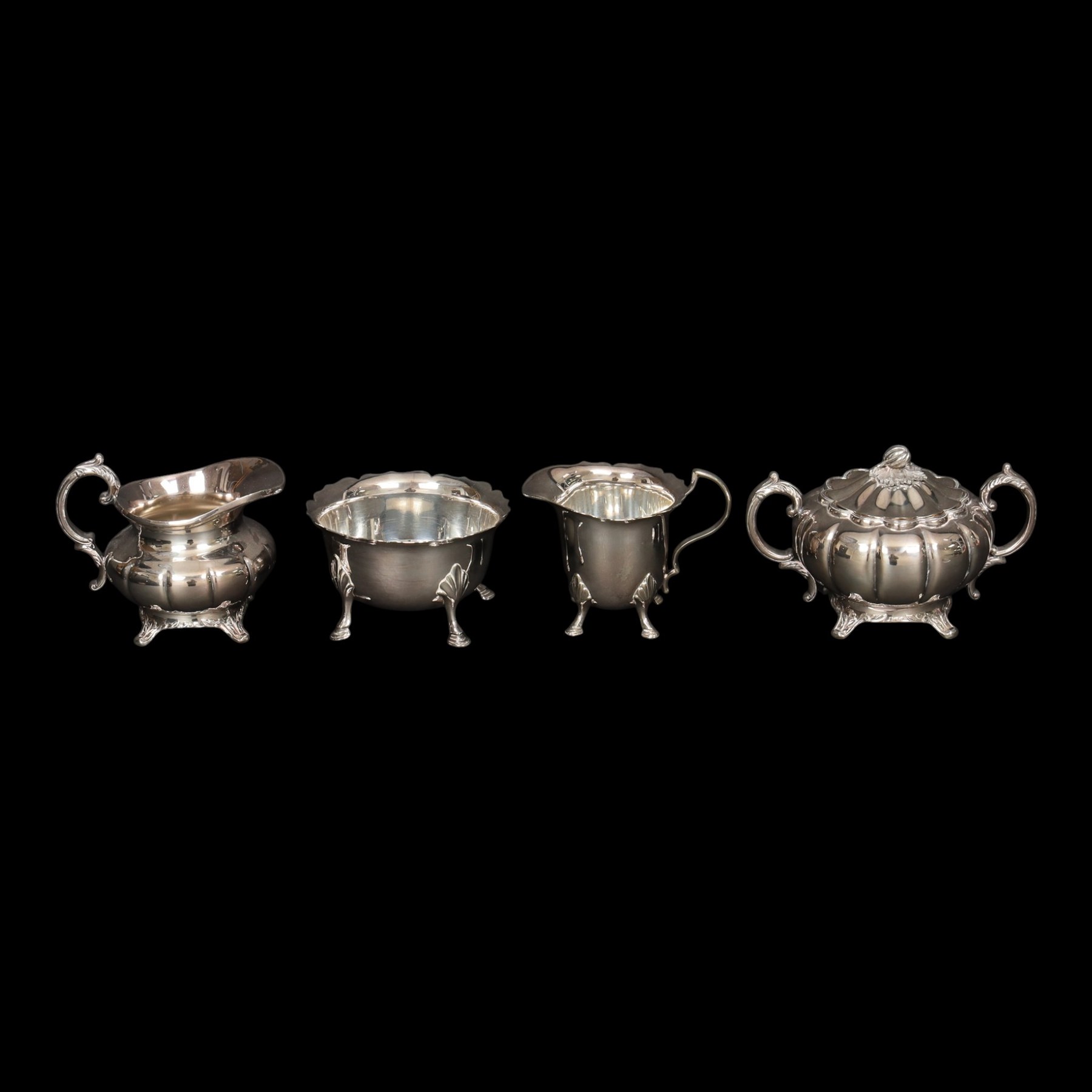 Silver plated four piece melon-shaped tea service by Viners Sheffield, comprising teapot, hot water jug, milk jug and covered sucrier, together with another silver plated tea service 