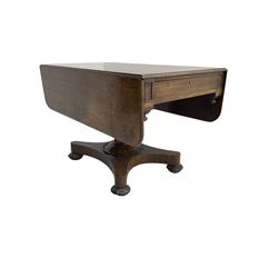 Early 19th century figured mahogany supper table, rounded rectangular drop leaf top with moulded edge, fitted with drawer to each end, turned pedestal on shaped platform, lobe carved compressed bun feet with recessed castors 