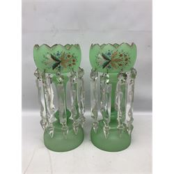 Pair of bohemian green glass lustres, each with a shaped bowl painted with stylised floral and foliate decoration supporting cut clear glass lustre drops upon central column, H34cm