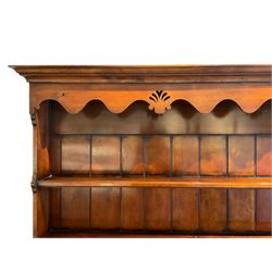 George III design cherry wood dresser, the projecting cornice over shaped frieze with pierced shell decoration, fitted with three shelves over six spice drawers, the base fitted with three long and two short drawers with cock-beaded facias, shaped and pierced apron over turned supports and panelled pot board base 
