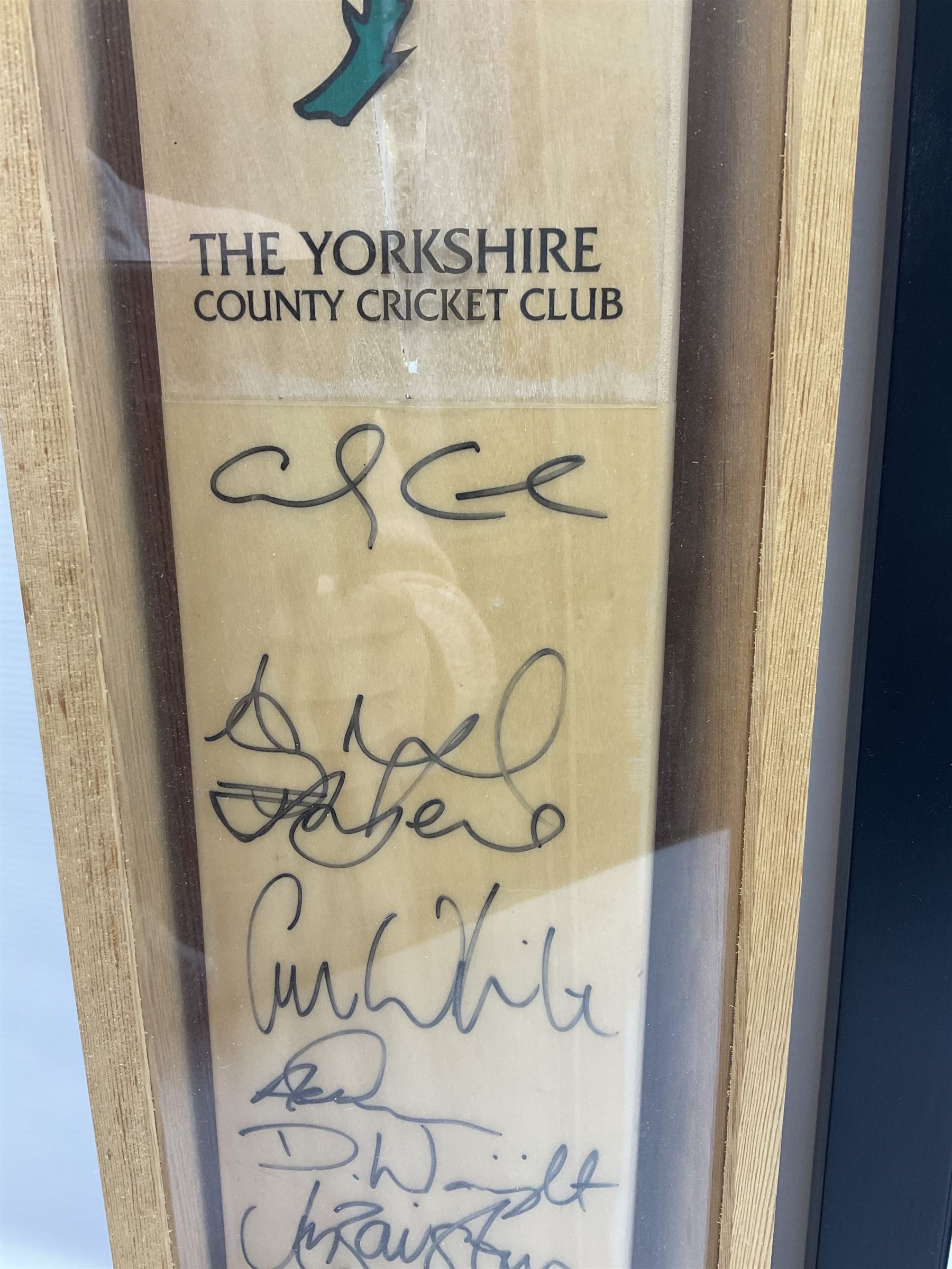 Two signed Yorkshire County cricket bats, bearing signatures including Anthony McGrath, Jacques Rudolph, Michael Vaughn and Matthew Hoggard, etc, both within glazed presentation boxes, box H86.5cm, together with a framed Darren Gough signed presentation print by Gary Keane