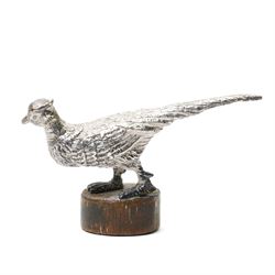 Silver model of a bird perched on a branch and with wooden base by Goldsmiths and Silversmiths Co. H5cm, small silver model of a pheasant on wooden base H2.5cm and a silver miniature model of a dog in a basket marked 925 and indistinct maker's mark L3.5cm (3)