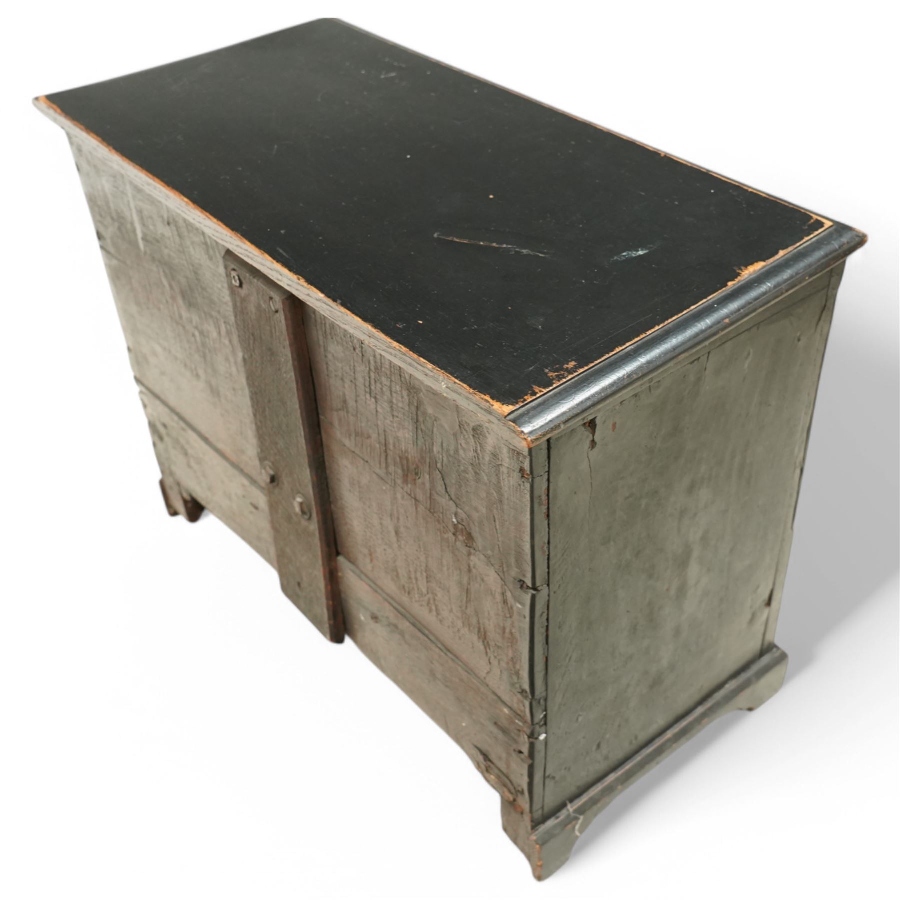 18th century and later oak coffer bach, moulded hinged lid over panelled front and single drawer, shaped and stepped arch panels, on bracket feet, in black paint finish