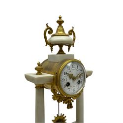 French - Late 19th century 8-day white marble and gilt metal portico clock garniture, the clock surmounted by an urn and raised on a pair of cylindrical pillars above a rectangular plinth base, white enamel dial with Arabic numerals and floral garlands, twin train countwheel striking movement, striking the hours and half hours on a bell, with a sunburst pendulum and gilt Louis XVI hands, garniture with matching twin light candelabra. With Key.   Candelabra H 30cm.