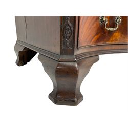 Chippendale design serpentine chest, shaped moulded top carved with repeating flower head motifs, fitted with brushing slide over four graduating drawers, pierced and foliate moulded handle plates with scrolled swan neck handles, canted upright corners carved with flower heads and strapwork, on canted ogee bracket feet
