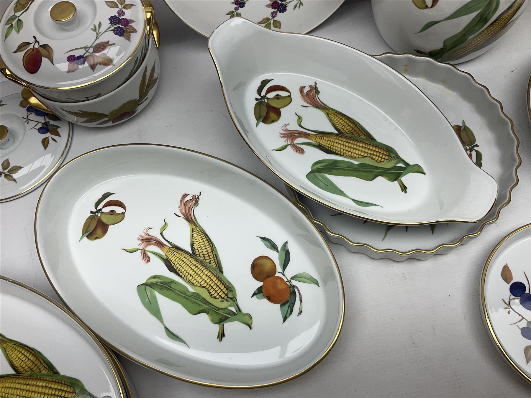 Royal Worcester Evesham pattern, including covered pot de cremes, twin handle tureen, serving dishes, flan dishes, side plates etc  
