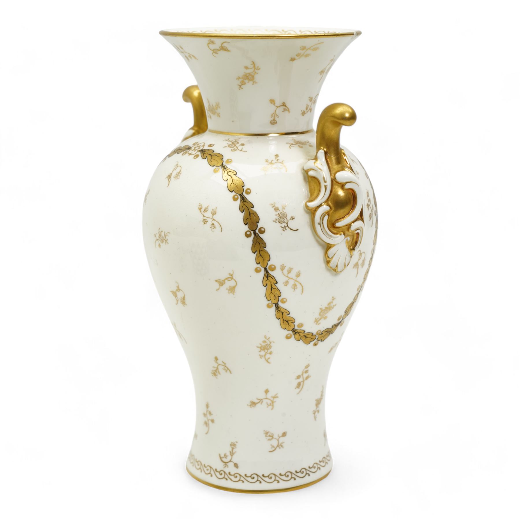 Early 20th century Royal Worcester porcelain twin handled vase, circa 1910, painted with a basket of flowers by Ernest Phillips, within an oval gilt border, the plain ground decorated with gilt sprigs and trailing oak leaves, signed, printed marks beneath, H21.5cm