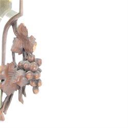 Late 19th century Continental carved wooden easel mirror, probably Black Forest, the shaped and bevelled mirror plate with surround carved with fruiting vines and surmounted with the figure of a cherub, with easel support verso, H72cm