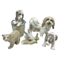 Five Lladro figures, comprising Lhaso Apso no 4642, Dog in Basket no 1128, Beagle Puppy no 1128, Attentive Bear no 1204 and Rabbit Eating no 4773, largest example H19cm 