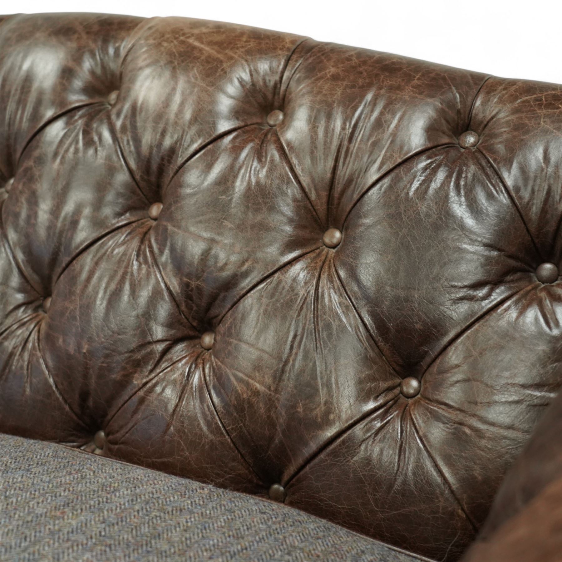 Tetrad - Harris Tweed and leather upholstered Chesterfield sofa, curved back and arms  with deep buttoned brown leather upholstery above loose herringbone tweed seat cushions with brown leather piping, raised on turned wooden feet 