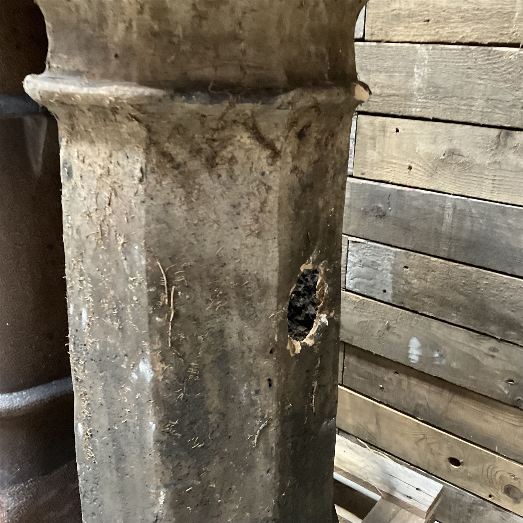 Collection of three Victorian and early 20th century reclaimed terracotta chimney pots, comprising: one cylindrical form with weathered, cracked glaze and flared octagonal base; one deep red cylindrical pot with fluted midsection and castellated rim, bearing moulded number ‘25’; and one tapering hexagonal example with wide flared rim and weathered patina. All with age-related wear and chips, consistent with use and outdoor exposure. Plus a selection of cast stone pieces including fountain 