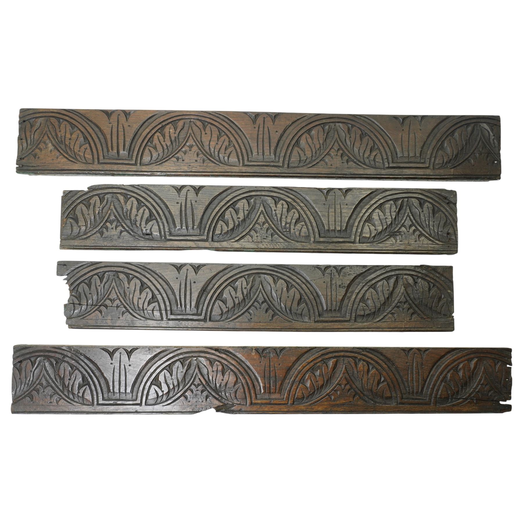 Indian teak panel with bird and floral carving, c. early 18th century, W34cm; together with four friezes with reaping carved arch decoration, each approximately W71cm (5)