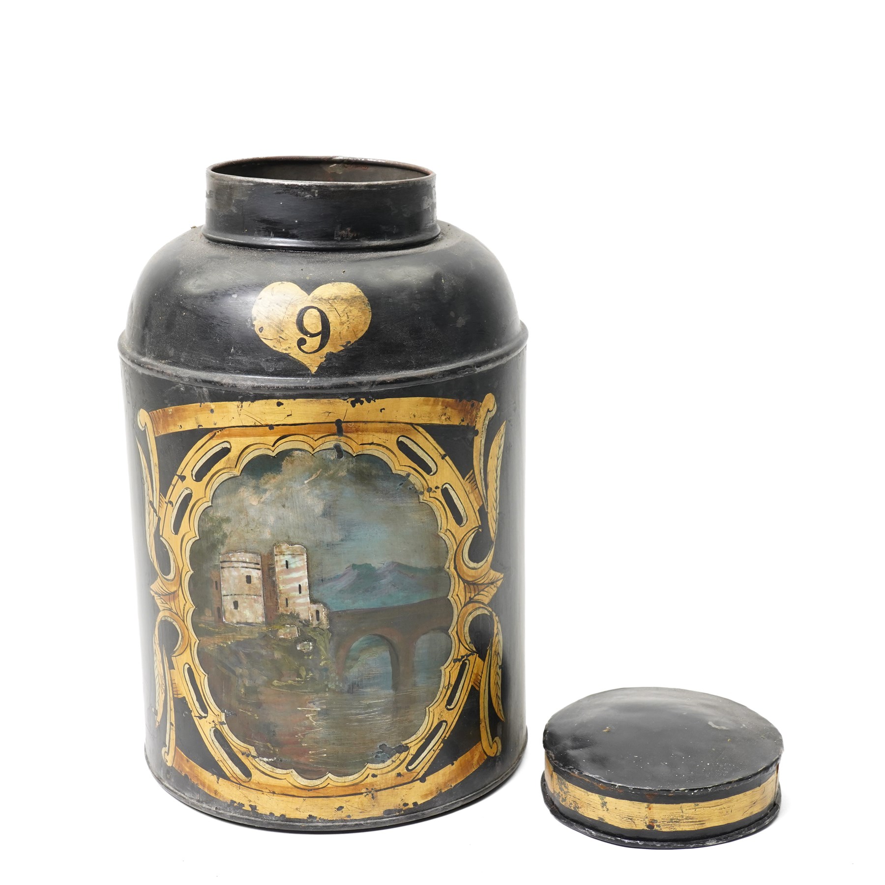 Regency period black toleware canister, painted with a scene of a castle with mother of pearl inlay, within painted gilt border, H39cm 