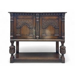Jacobean design carved oak two door cupboard, the frieze and twin cupboard doors carved wi...