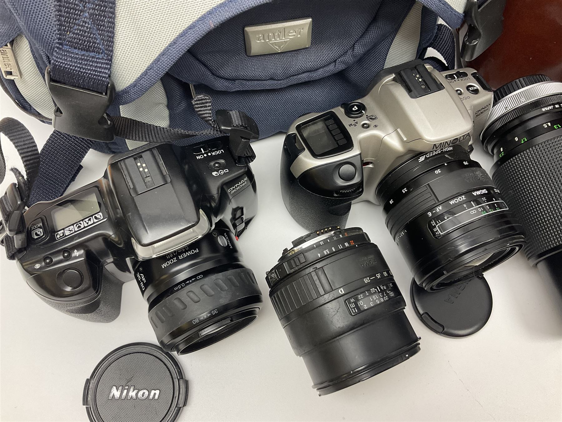 Four Minolta camera bodies, to include Dynax 500si, serial no. 94812651 with 'Signa Zoom 1;3.5-4.5 f=28-70mm' lens, Maxxum 300si, serial no. 97821665, with 'Tamron AF 80-210mm' lens and Dynax 300si, serial no 01603265'  with Minolta AF Power Zoom 35-80mm 1;4' lens, etc, together with Pantax MV1 camera bodies and other camera equipment 