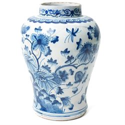 18th century Dutch Delft plate of fluted design decorated in blue and white with figures in a landscape D29cm and a Dutch Delft vase decorated in blue and white with oriental flowers H21cm (2)