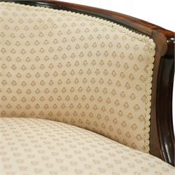 Victorian mahogany upholstered settee, the shaped back with pierced foliate carved cresting, upholstered in cream patterned fabric with serpentine seat, on cabriole front legs with brass castors
