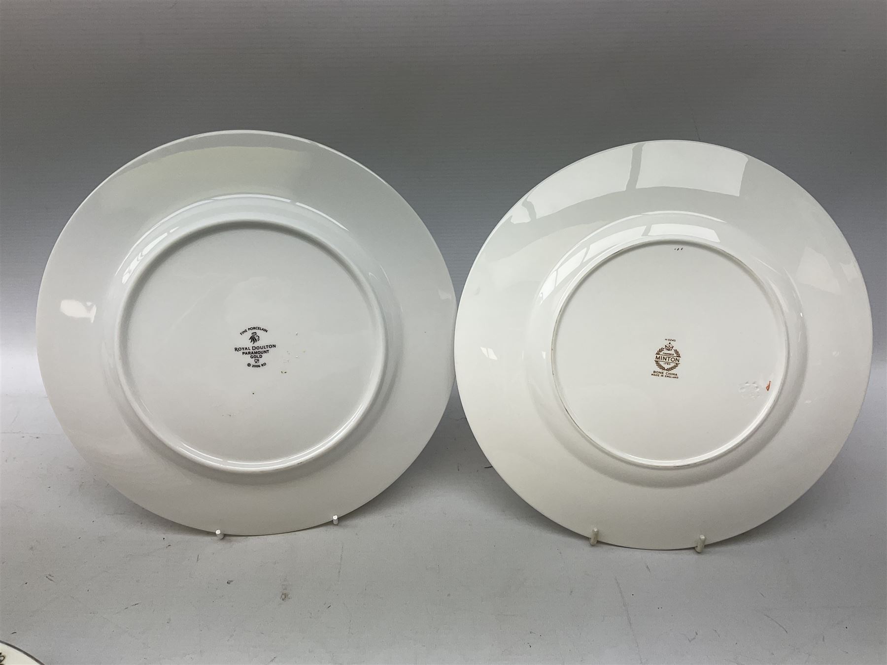 Seven Minton dinner plates, with gilt decoration and the Royal crest, together with six Royal Doulton plates in Paramount Gold pattern