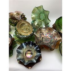 A collection of Carnival glass, to include marigold, green, and amethyst, bowls, dishes, and comports, various patterns including fruiting vines, peacocks, and an example decorated with a Horseshoe and detailed Good Luck. 
