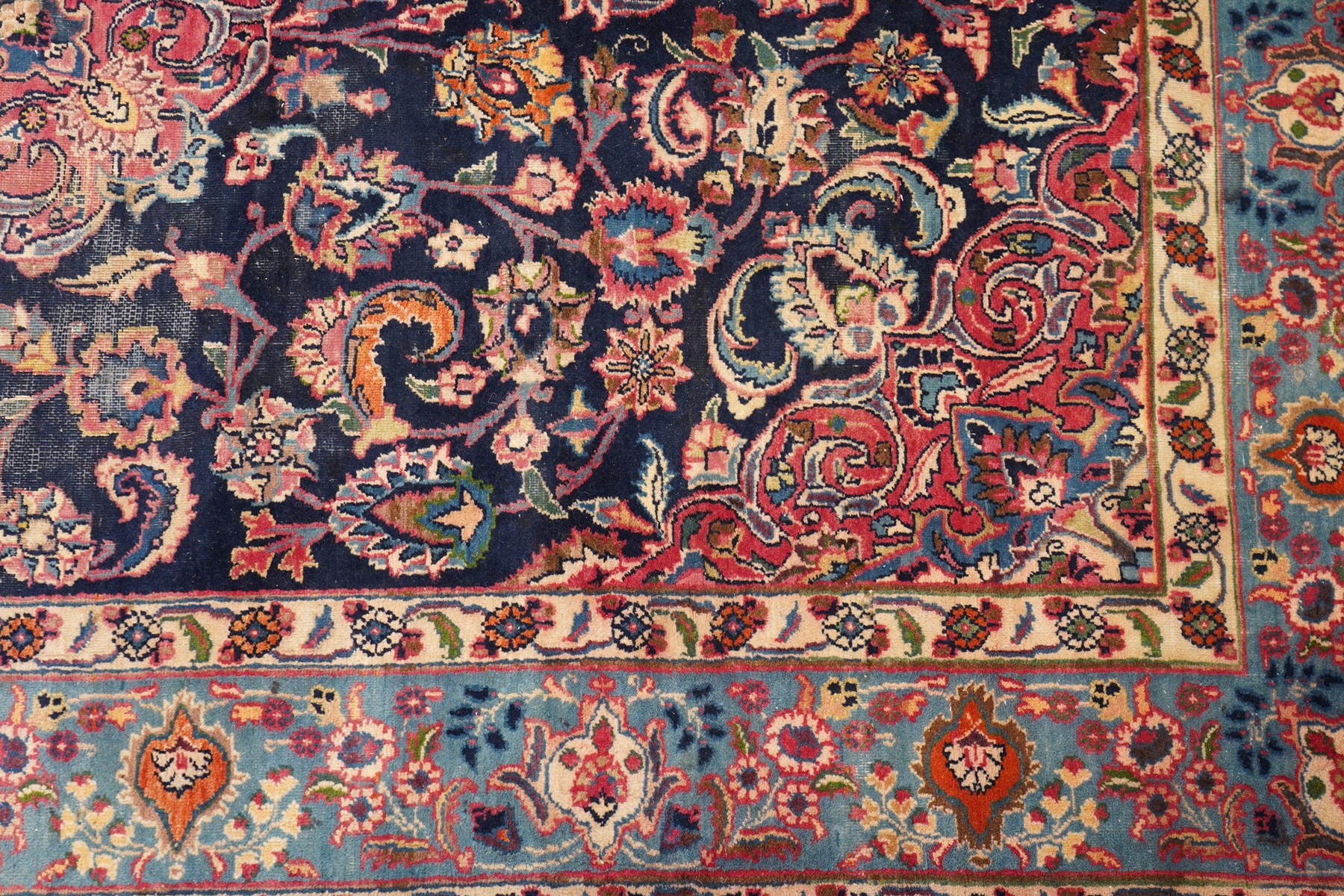 Vintage Persian Tabriz indigo ground rug, the central floral medallion within a field woven with scrolling palmettes and plant motifs, with contrasting spandrels, the the cyan guard lines with scrolling floral patterns