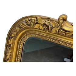 18th century design ornate gilt framed overmantle mirror, bevelled mirror plate within arched frame with pierced pediment featuring foliate and scrollwork designs