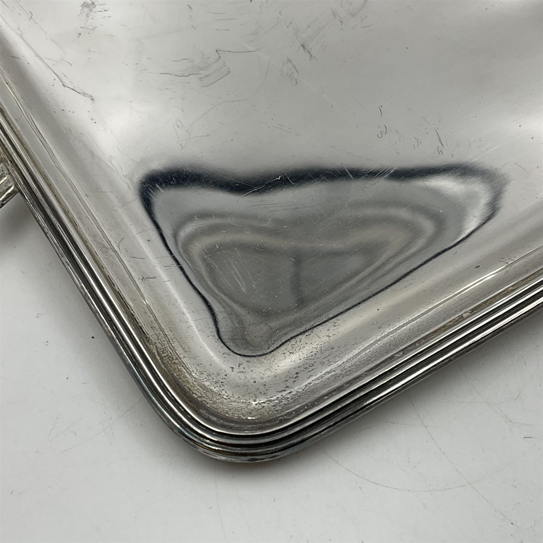 Small early 20th century silver tray, of rectangular form with reeded edge and twin reeded handles, hallmarked Asprey & Co Ltd, London 1914, including handles W26.5cm