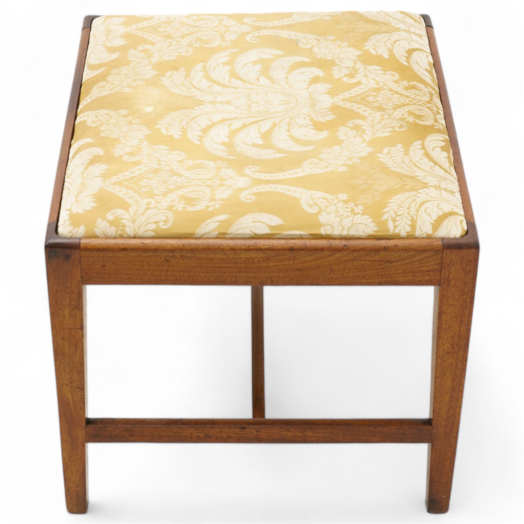 George III mahogany rectangular stool, the seat upholstered in silk damask fabric decorated with foliate pattern, on square tapering supports united by H-stretchers 