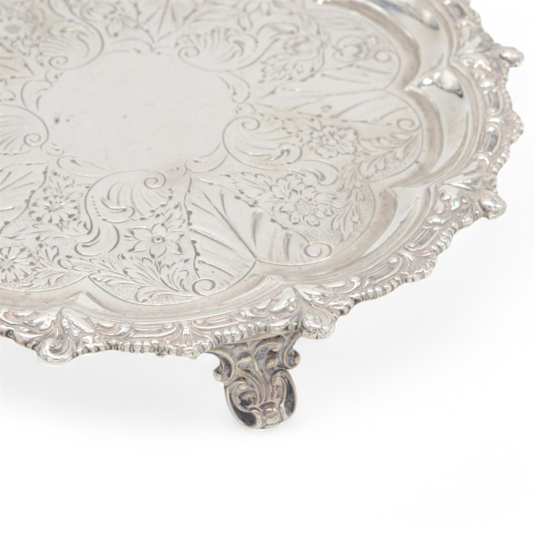 George IV silver waiter, of typical form, with shaped rim embossed with C scrolls, upon three scrolling pad feet, hallmarked William Brown London 1829, D20cm
