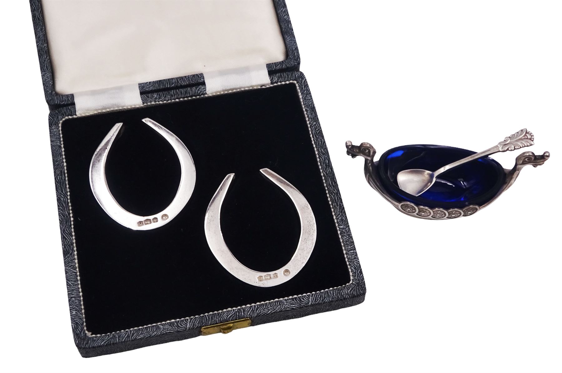 Pair of mid 20th century silver horseshoe napkin rings, hallmarked Francis Howard Ltd, Sheffield 1959, in velvet and silk lined fitted case, together with a Norwegian silver open salt, in the form of a Viking long boat, stamped 925 S Sterling Norway to base, with Norwegian silver salt spoon, stamped Sterling Norway and blue glass liner, H4.4cm, approximate weighable silver 2.5 ozt (77.6 grams)