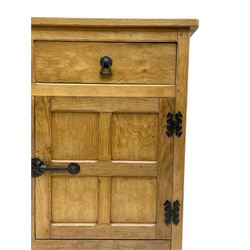 Acornman - adzed oak sideboard, fitted with three drawers and four cupboards enclosed by panelled doors, all-over adzing and iron fixtures, with acorn signature to lower front foot, by Alan Grainger of Brandsby