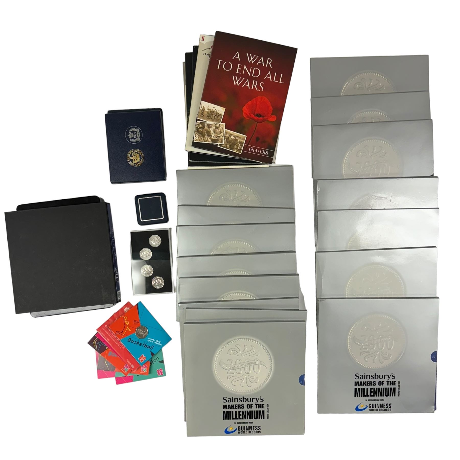 Mostly commemorative coins, medallions and fantasy coinage, including various 'Sainsbury's Makers of the Millennium' medal collection folders containing various medallions, The Toer Mint commemorative four medallion set in fitted case, Queen Elizabeth II 1982 silver proof piedfort twenty pence coin cased with certificate, various part filled The London Mint office folders etc