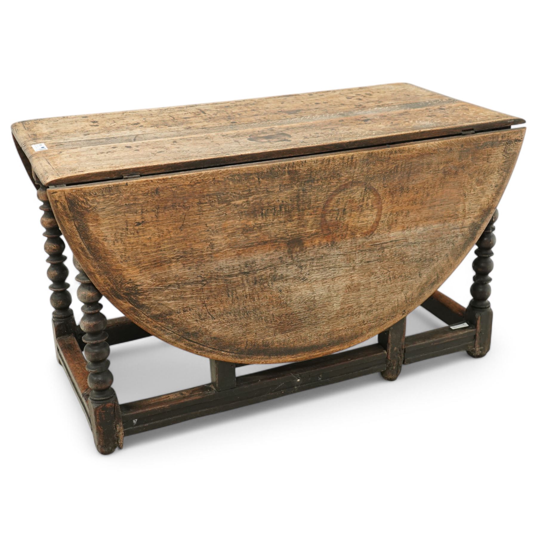 Late 17th century oak drop-leaf dining table, oval drop-leaf top on gate-leg action base, bobbin turned supports untied by moulded stretchers 