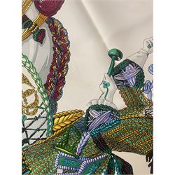 Hermès 'Le Timbalier' silk scarf, designed by Francoise Heron in 1961, printed with a central image of a gentleman on horseback donning extravagant dress, on white ground surrounded with colourful stylised knotted ropes, contained within peacock blue border, with rolled hand stitched edges and Hermes material label, 87cm square