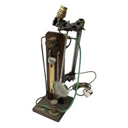Industrial style table lamp, repurposed from a Griffin & Tatlock measuring apparatus with glass instruments fixed to a wood base, with magnifying glass, H45cm, and a Metal Corinthian column table lamp, H47cm
