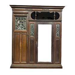 Victorian mahogany wardrobe, projecting cornice over cushion moulded frieze carved with cartouche and scrolls, the left hand compartment enclosed by stained glass panel glazed door with Gothic arched panels, the right hand side enclosed by bevelled mirror glazed door, fitted with open top box, carved with acanthus leaf and gadroon decoration, egg and dart moulded and dentil frieze cornice, stepped and moulded plinth base