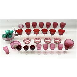 Collection of victorian and later cranberry glass, including wine glasses with clear stems, a footed bowl, other coloured glass etc