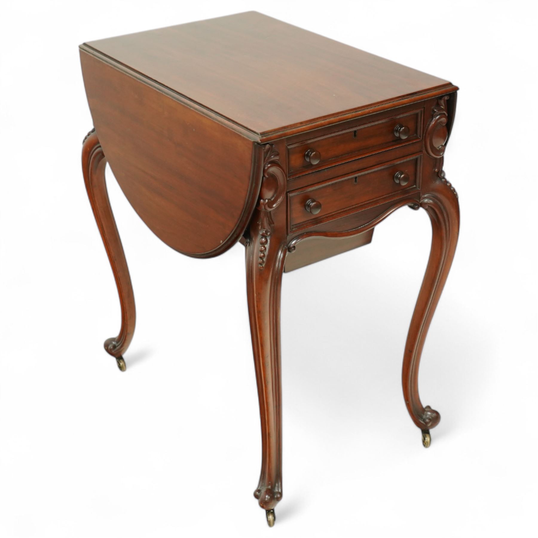 Victorian mahogany drop-leaf work table, the rectangular top with rounded hinged leaves above a bank of three drawers and opposing dummy drawers, fitted with a sliding work box, carved scroll and foliate knees, on cabriole supports with brass castors