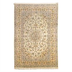 Central Persian Kashan hand-knotted carpet, ivory ground with central rosette medallion su...