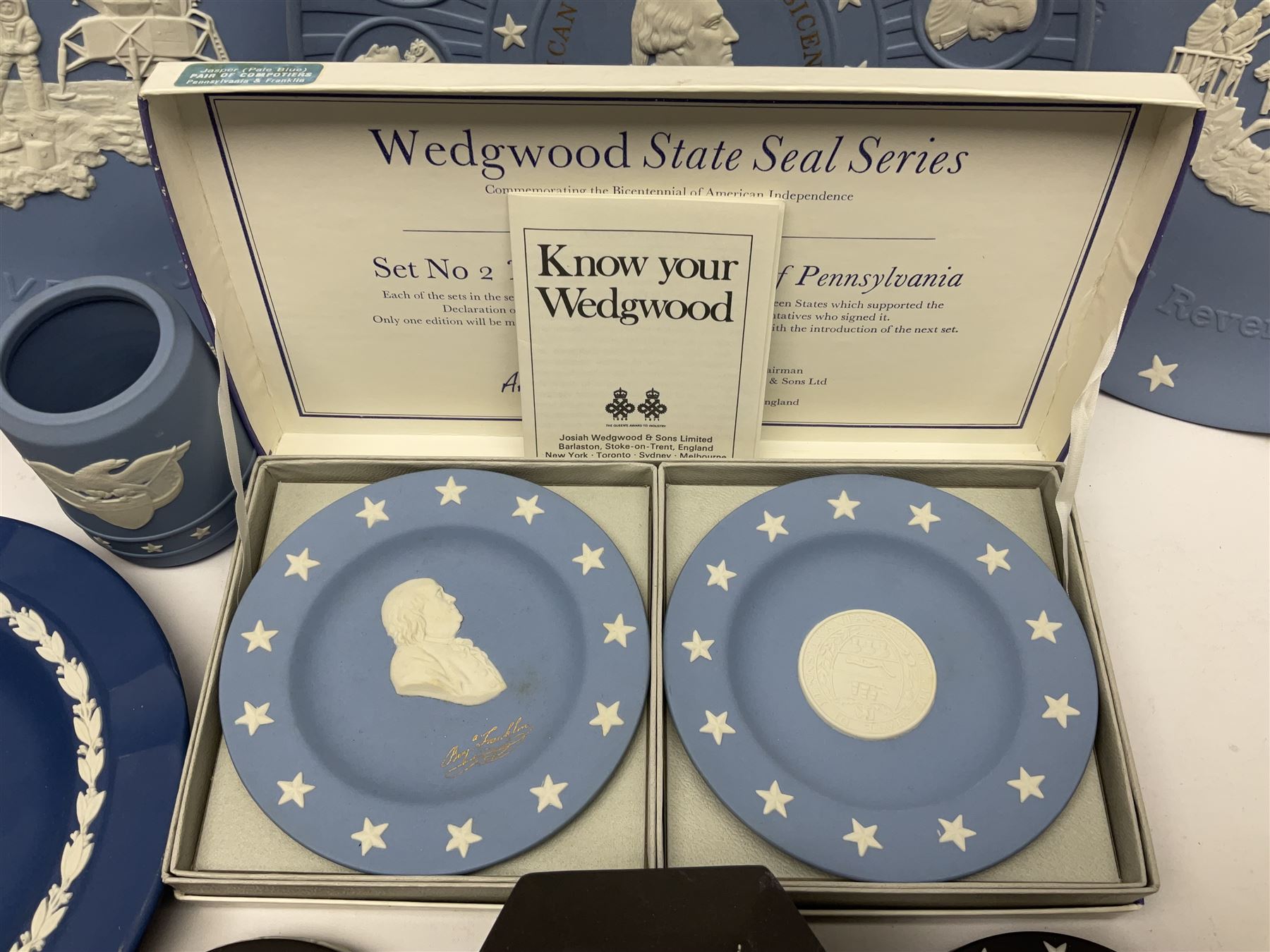 Collection of Wedgwood Jasperware, to include black Eisenhower Bust, two black basalt paperweights, one depicting an eagle and one depicting Julius Caesar, a blue Zodiac plate, Man on the Moon commemorative plate, American Independence Bicentennial plate and Royal commemorative ware, etc, all with impressed marks beneath, some with boxes