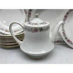 Royal Albert Paragon tea and dinner service for twelve decorated in the Belinda pattern, comprising fourteen saucers, twelve teacups, thirteen side plates, teapot, sauce boat and stand, salt and pepper shakers, two jugs, sucrier, twelve dinner plates, twelve smaller plates, two lidded tureens, twelve bowls, twelve smaller bowls, cake plate, oval plate and oval dish (100)