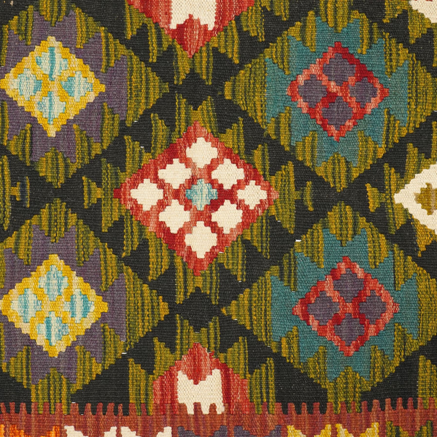 Afghan Maimana flatweave kilim runner, central field features large bold nested diamond motifs and stylized geometric lozenge patterns on olive purple, blue, and green tone ground, border stripe in green ground, and fringe
