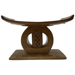 20th century African Ashanti hardwood stool, dished seat over a carved base in the form of an elephant (W52cm D30cm H50cm); with another similar, the dished seat over a circular support with carved and pierced central totem (W58cm D23cm H37cm)