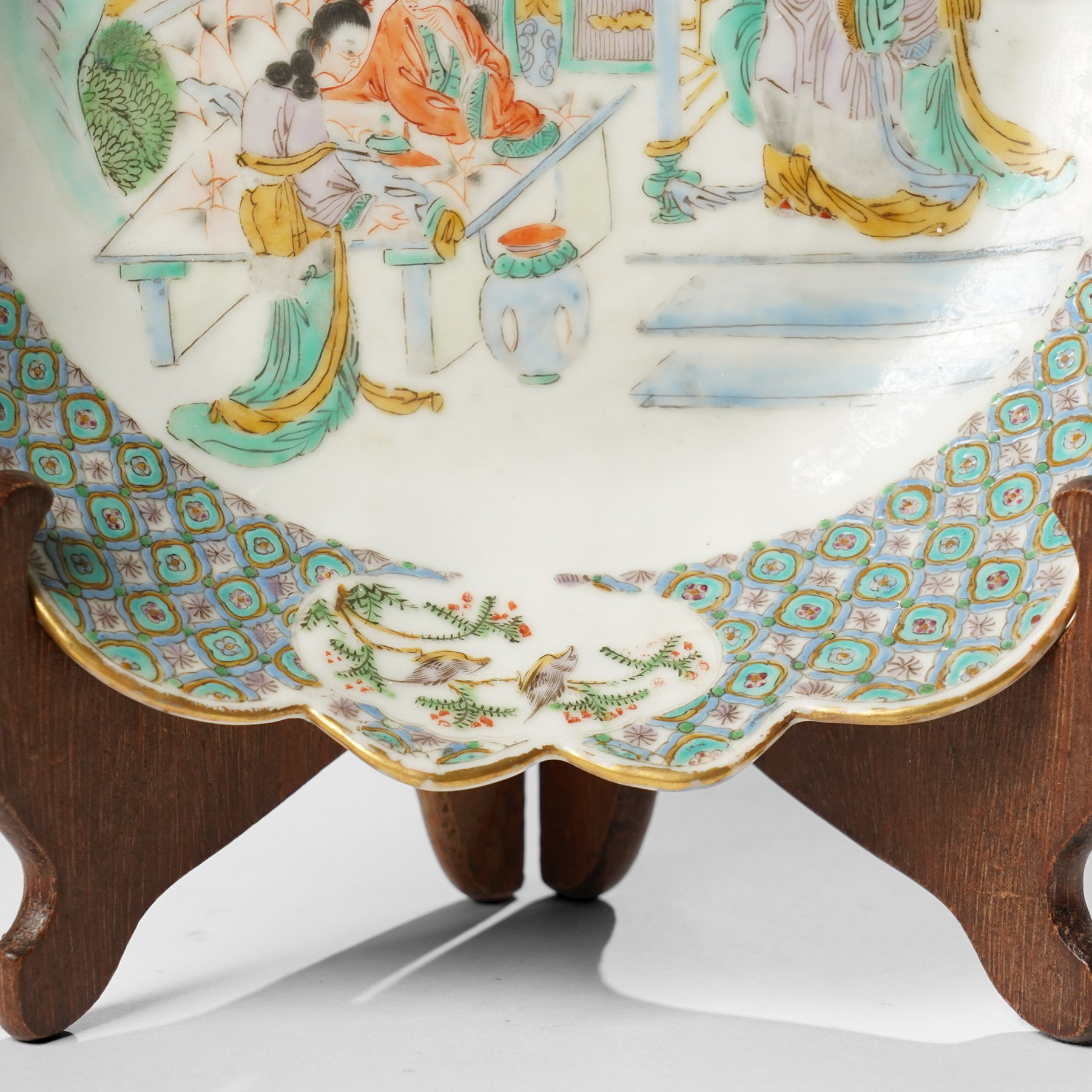 Chinese Kangxi period famille verte bowl, painted with seven figures in a pavilion interior, in Cantonese style border with foliate rim, the exterior painted with similar scenes, D24cm
