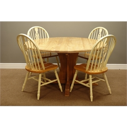  Circular polished pine pedestal dining table (D141cm, H73cm), and four wheel back chairs  