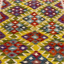 Afghan Maimana kilim flatweave runner, central field features large bold nested diamond motifs and stylized geometric lozenge patterns on olive purple, blue, and green tone ground, border stripe in teal ground, and fringe