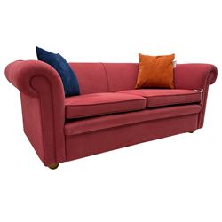 Two seat Chesterfield sofa, upholstered in salmon fabric, on turned bun feet