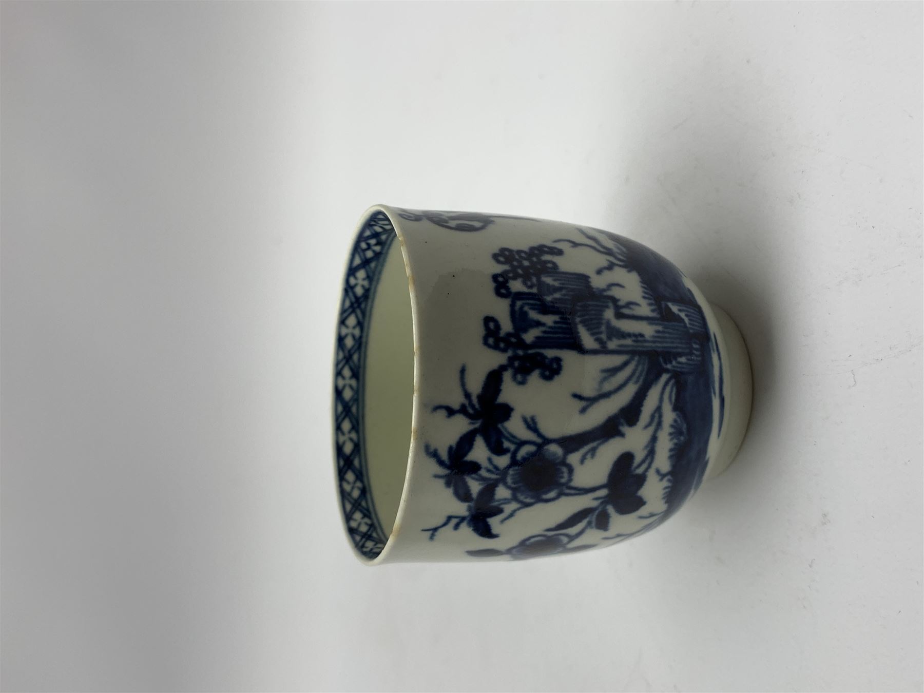 18th Century Worcester teapot, circa 1765-70, decorated in the Bird in the ring pattern, the cover with bud finial, with crescent mark beneath, H13cm, together with a Worcester coffee cup decorated in the same pattern, with crescent mark beneath, H6.5cm