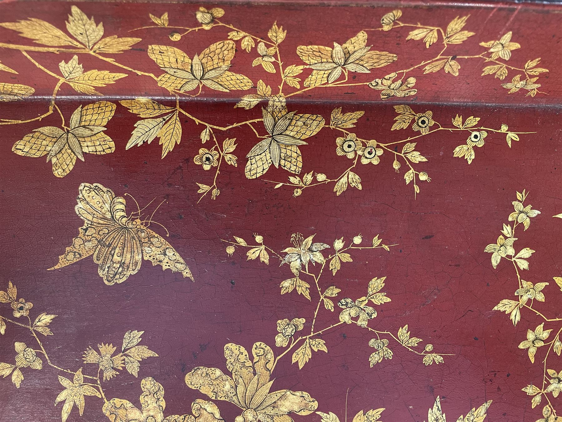 Early 19th century red lacquered papier-mâché tray by Clay of King Street Covent Garden, of rounded rectangular form, painted in gilt with large foliate sprays and butterflies, impressed verso CLAY KING ST COVENT GARDEN, W66.5cm D48.5cm