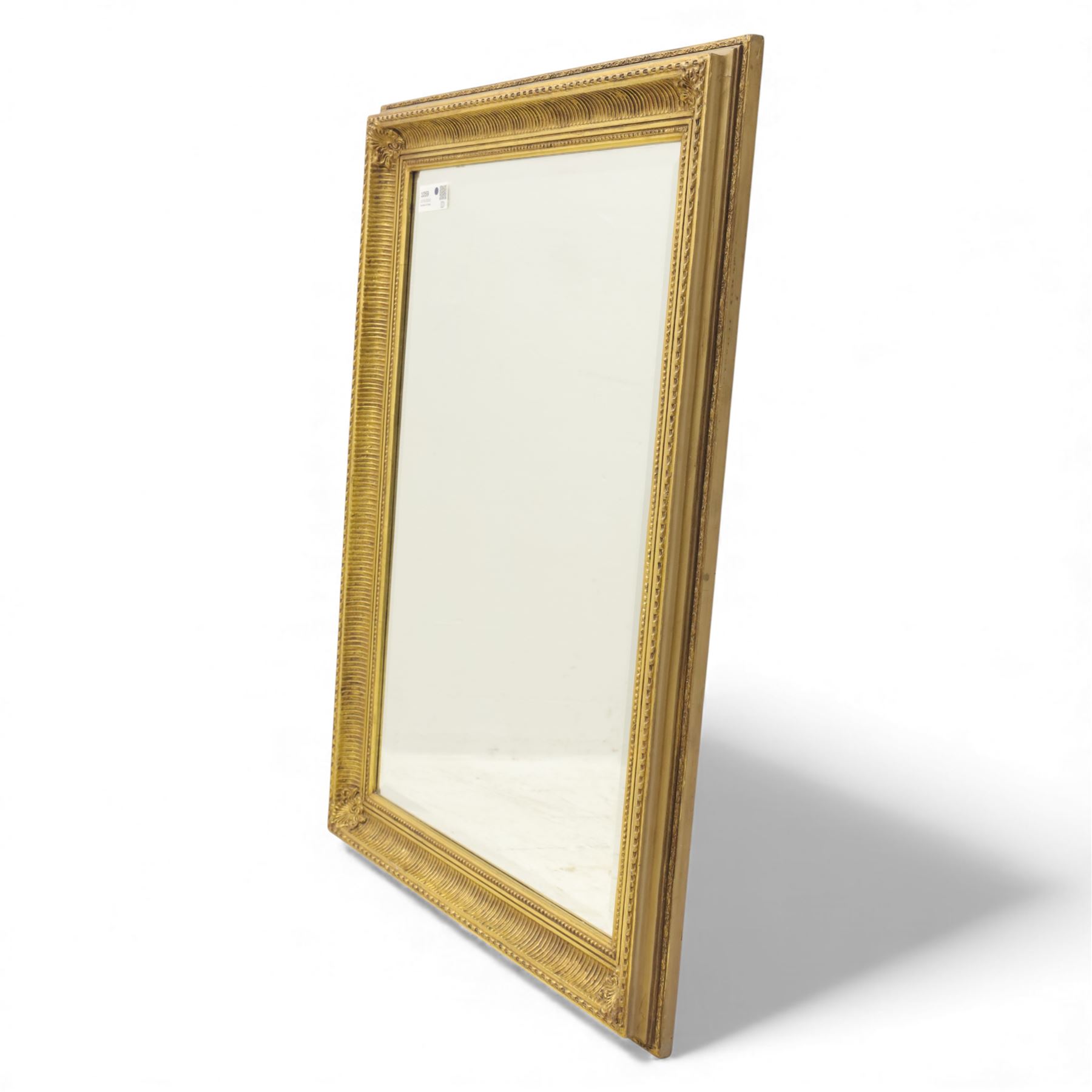 Two late 20th century gilt mirrors, foliate and dart detailing to the frame (H 92cm, W 66cm; H 53cm W 45cm)