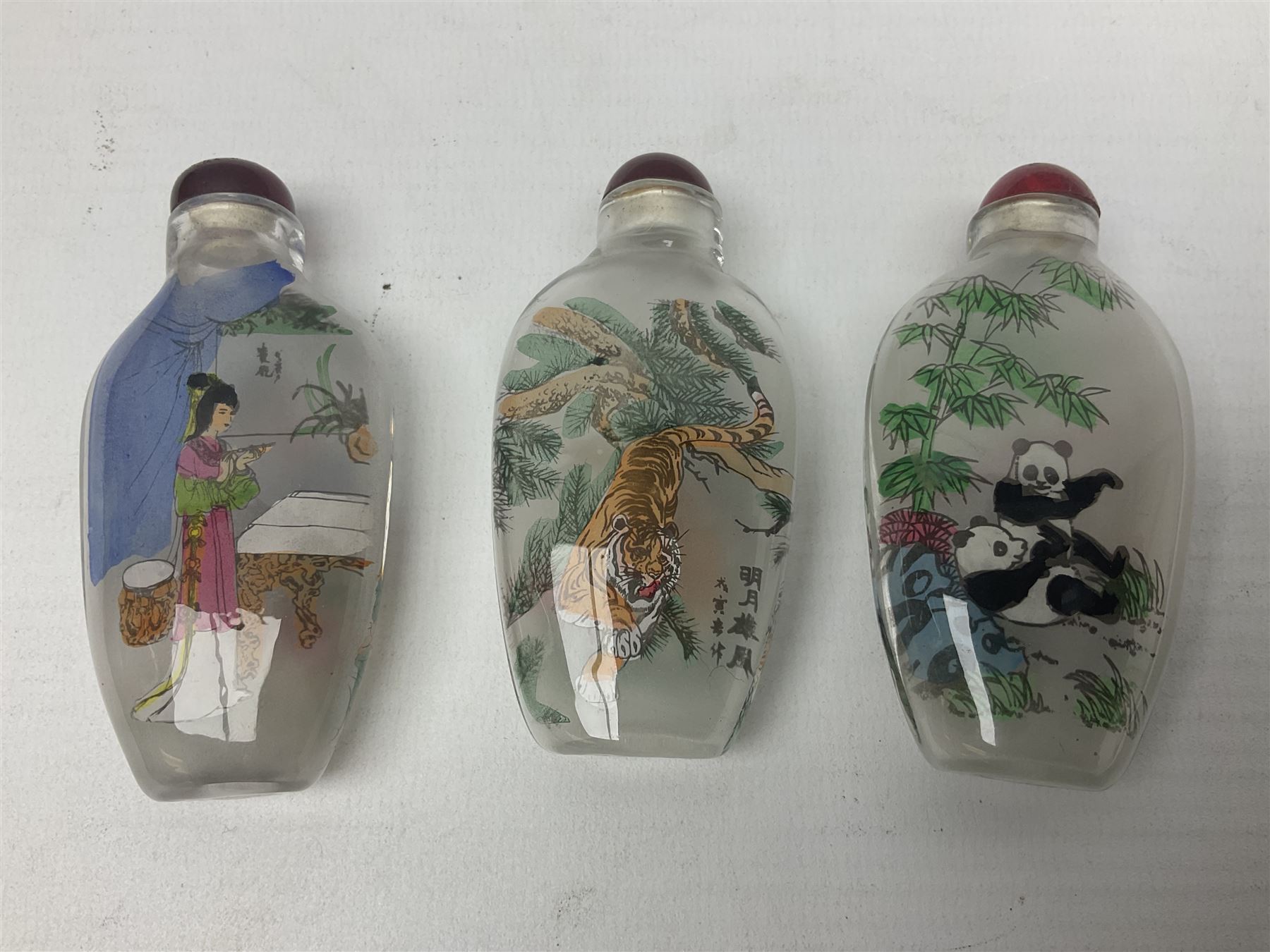 Seven Chinese glass snuff bottles painted with figures and animals, together with three wood mounted bone examples